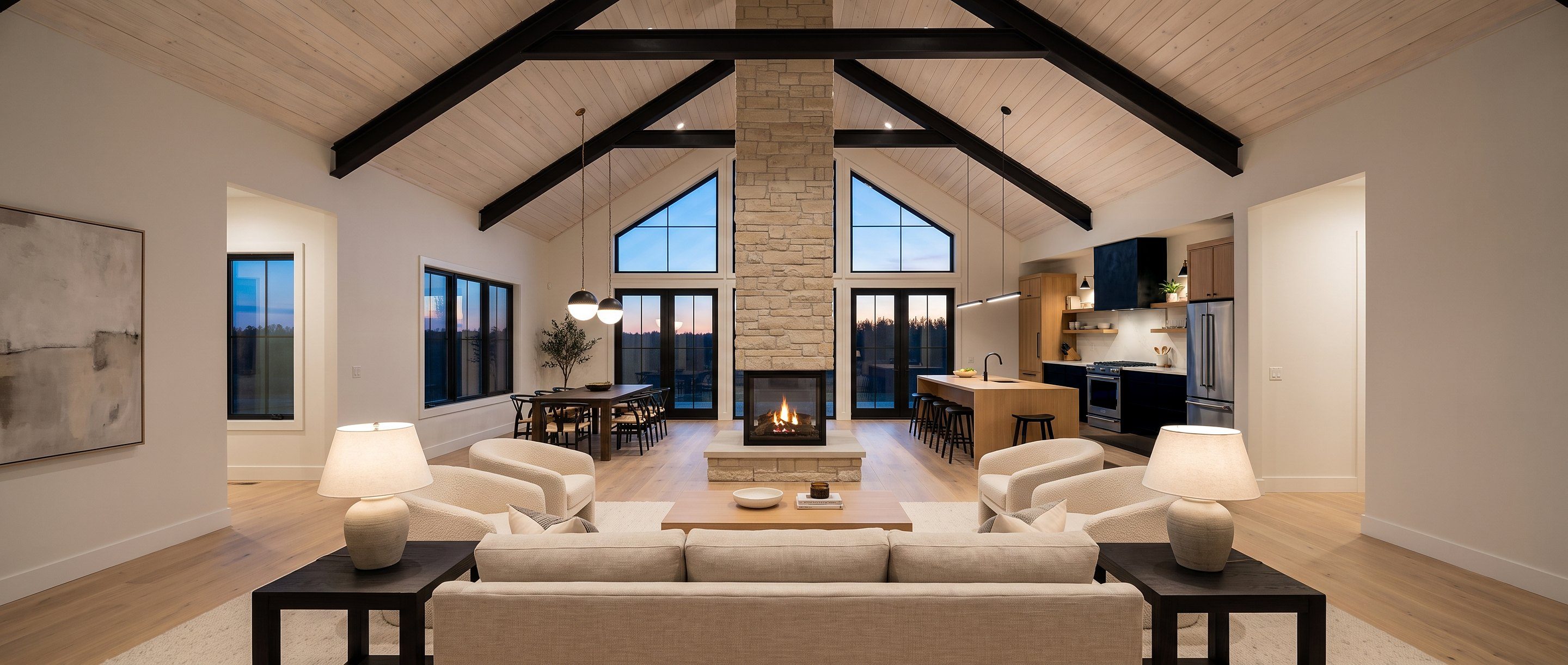 The Sonoma living room with fireplace, open kitchen, and vaulted ceiling